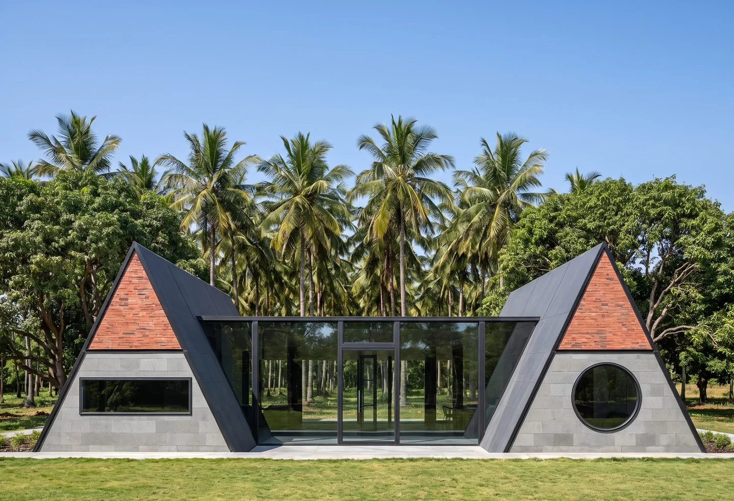 A long single-storey villa with a tiled A-frame at each end and a glazed living room between them