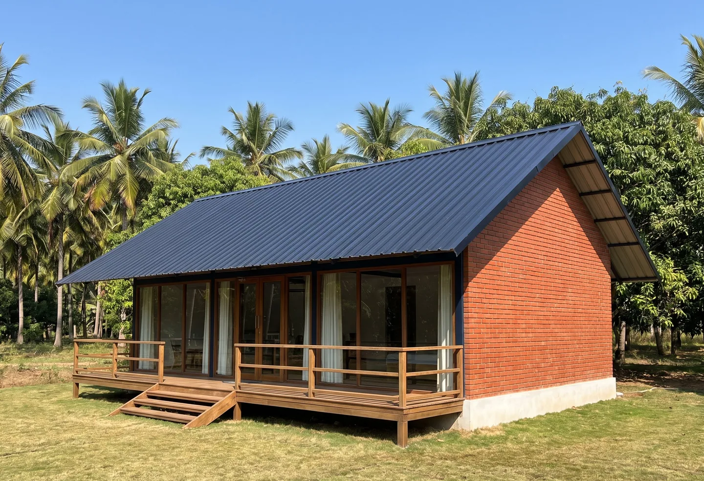 A single-storey farm cottage with a pitched roof, a brick end wall and a railed verandah